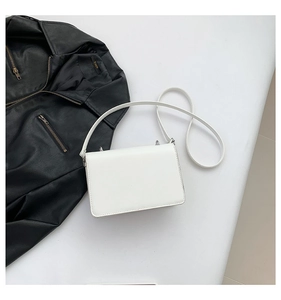 Detailed top view of white minimalist rectangular crossbody bag with premium leather texture