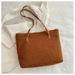 Vue détaillée du grand sac cabas en peluche marron avec anses fines sur fond blanc esthétique