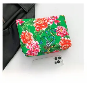 Detailed top view of ethnic floral nylon pouch with vibrant phoenix and peony prints