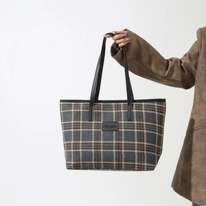 Stylish grey plaid tote bag with black leather straps and large storage capacity