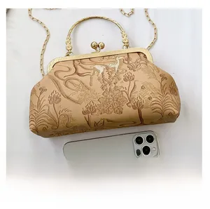 Detailed size comparison of beige vintage patterned clutch bag with a smartphone