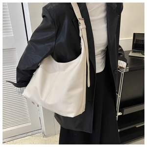 Close-up of beige large capacity hobo bag with adjustable strap on professional model