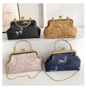 Detail of four vintage clasp bags with floral deer embossing in black and beige colors