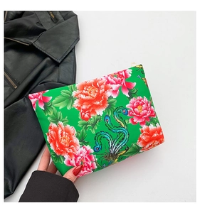 Detailed view of floral nylon clutch bag with peony pattern and golden zipper detail