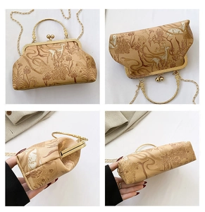 Detail view of vintage frame bag with floral deer pattern, gold handle and chain strap
