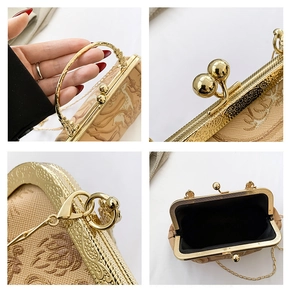 Detailed close-up of vintage deer embroidery and floral patterns on a clutch bag