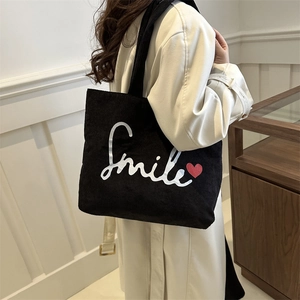 Minimalist black corduroy tote bag with Smile print and red heart, winter shoulder bag