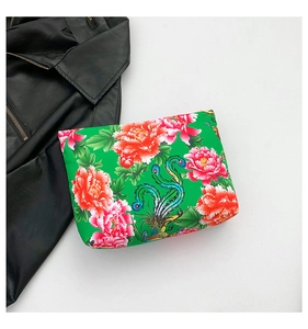 Detail of green nylon clutch featuring traditional Phoenix and Peony floral prints