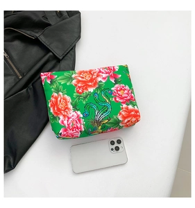 Detail view of ethnic nylon clutch bag with red peony and phoenix prints for women
