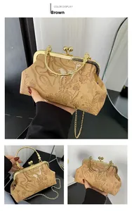 Detail view of vintage frame bag with floral deer print and gold metal chain