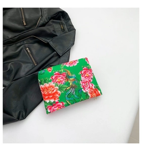 Detail of green nylon clutch bag with traditional Chinese Phoenix and Peony floral prints