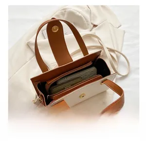 Top view of two-tone handbag showing spacious interior compartments and magnetic closure