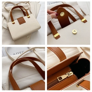 Detail of beige tote bag with litchi texture, magnetic buckle, and gold hardware accents