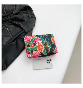 Close-up of nylon clutch bag with traditional red peony and phoenix prints