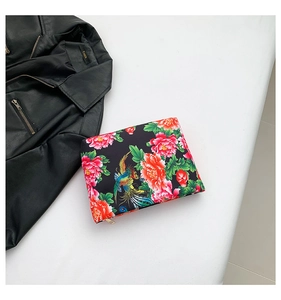 Flat lay of floral nylon clutch featuring traditional peony and phoenix print