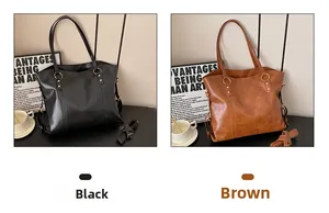 Detail view of large leather tote bags in black and brown with gold hardware accents