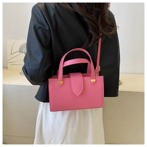 Pink lychee grain leather handbag with gold hardware and adjustable crossbody strap