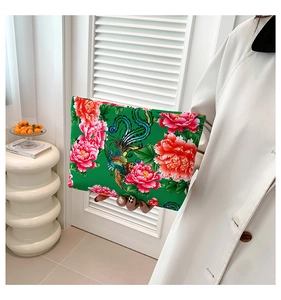 Detailed close-up of ethnic nylon clutch bag with phoenix and peony floral prints