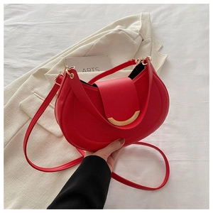 Detail of red crescent hobo bag with gold metal buckle and smooth leather texture