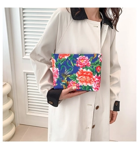 Ethnic nylon handbag featuring vibrant red peony and phoenix prints on a royal blue fabric