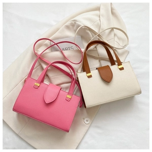 Flat lay of stylish lychee texture handbags in rose pink and beige colors with suits