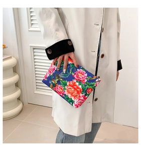 Close-up of ethnic style nylon clutch bag with phoenix and peony floral print pattern
