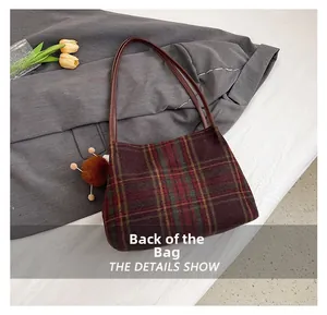 Back view of vintage red and green plaid tweed tote bag with decorative pompom charm