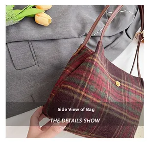 Detail view of large plaid wool tote bag showing side capacity and golden flower buckle