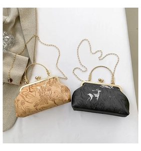 Detailed close-up of retro floral embossed metal frame chain bags in khaki and black
