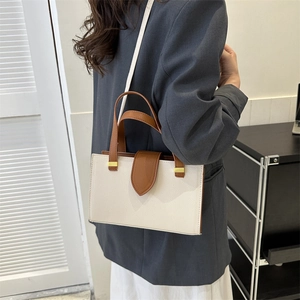 Minimalist beige and brown colorblock crossbody bag with textured pebble leather