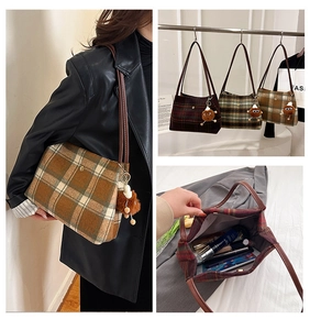 Detail of checkered tweed tote bag showing interior storage capacity and plush charm