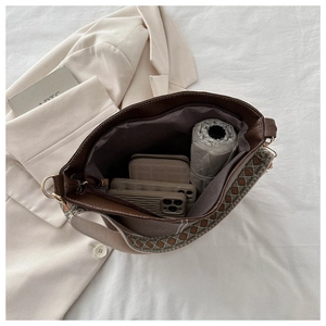 Top view of brown bucket bag interior showing spacious storage with ethnic wide strap