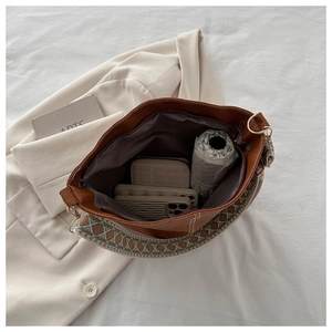 Interior view of brown bucket bag showing spacious storage for phone, wallet and umbrella