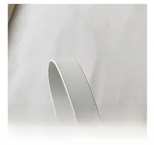 Detailed close-up showing the precise edge stitching of the white leather handbag strap