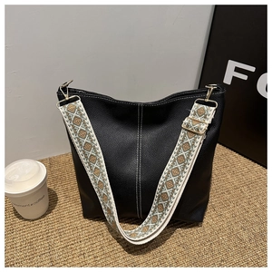 Retro black bucket bag with contrast stitching and ethnic geometric embroidery strap