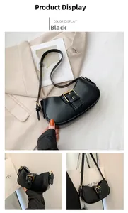 Detail view of the black crescent shoulder bag with a stylish golden buckle and adjustable strap