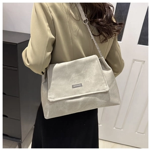 Détail du sac à bandoulière en similicuir gris clair avec bandoulière chaîne argentée
