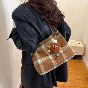 Vintage wool plaid tote bag in brown and green with a cute plush monster charm