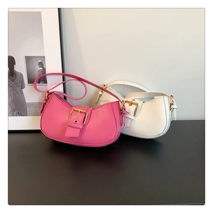 Detailed view of pink and white half-moon underarm bags with adjustable buckles