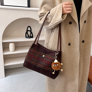 Plaid wool tote bag with golden flower detail and plush charm for autumn and winter style
