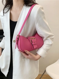 Fashionable pink leather underarm bag for women with a prominent gold buckle decoration