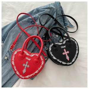 Detail of red and black heart-shaped Y2K crossbody bags with Baby and cross print