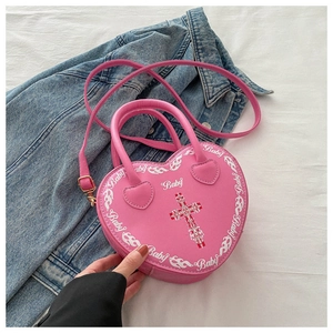 Close-up of pink heart-shaped bag featuring Baby print and Y2K aesthetic flame details