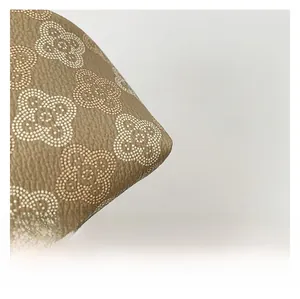 Macro di ecopelle marrone con stampa floreale bianca e trama dalla grana fine