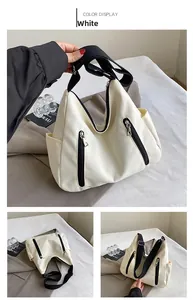 Détail du sac fourre-tout en toile blanche avec zips noirs et large bandoulière