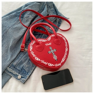 Detailed view of the red heart-shaped PU leather bag featuring gothic Baby print and cross
