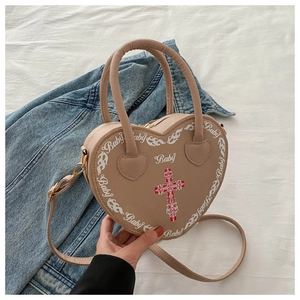 Detailed close-up of heart-shaped beige PU leather bag with Baby text and flame pattern