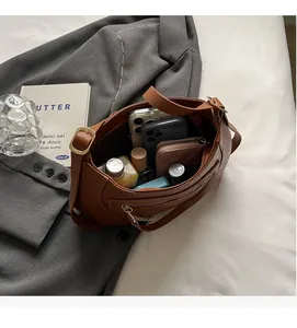 Interior view showing the large capacity of the brown faux leather tote with daily essentials