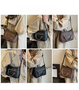Detail shots of minimalist leather crescent shoulder bags with chain decor and zip pockets