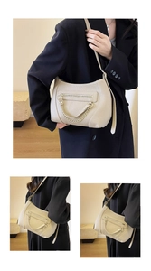 Detailed macro view of beige textured leather shoulder bag with gold chain and stitching